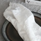Image of Terra Cruda's dining collection with the Puglia linen napkins